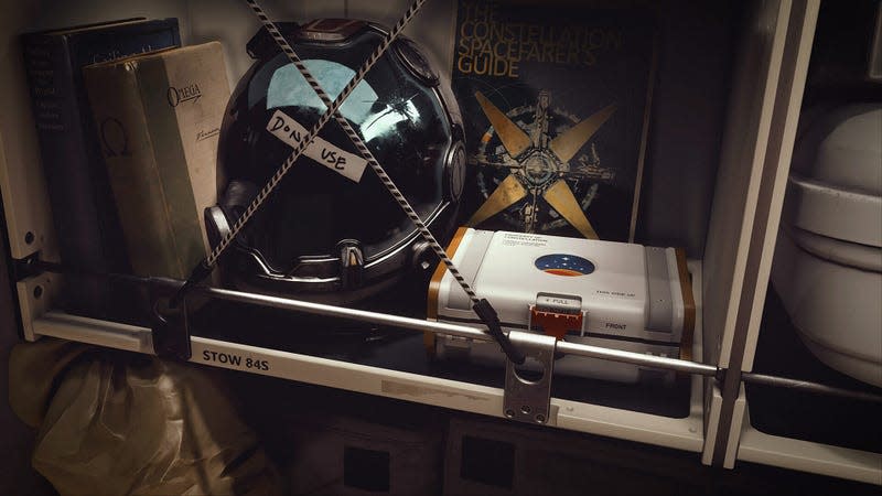 A helmet and books sit on a shelf.