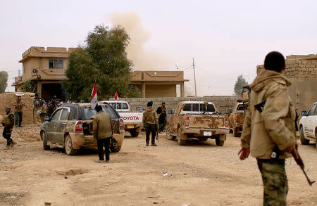 Smoke rises after a mortar is fired by Islamic State militants at members of the Lions of the Tigris, a group of Sunni Arab fighters and part of the Hashid Shaabi (Popular Mobilization Comimittee) during a military operation in Shayyalah al-Imam, Iraq November 30, 2016. REUTERS/Thaier Al-Sudani