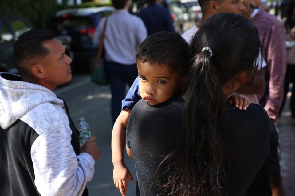 <div class="inline-image__caption"><p>A mother and child outside St. Andrew’s parish house, where migrants were being fed lunch with donated food from the community on Martha’s Vineyard.</p></div> <div class="inline-image__credit">Jonathan Wiggs/The Boston Globe via Getty</div>