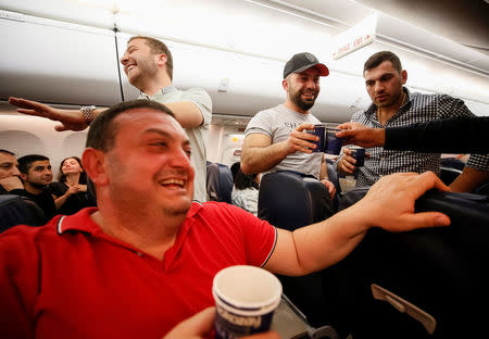 Armenians celebrate during a flight from Kiev, Ukraine, to Yerevan, Armenia, after Armenian Prime Minister Serzh Sarksyan resigned following almost two weeks of mass street protests, April 23, 2018. REUTERS/Gleb Garanich