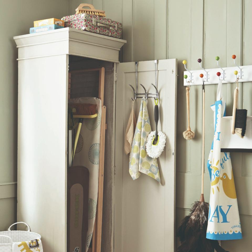 A cleaning cupboard with cleaning supplies