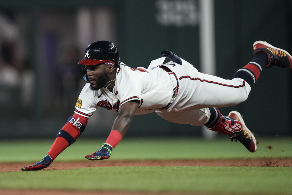 Atlanta Braves' Michael Harris II (23) dives into second base on an RBI double in the sixth inning of a baseball game against the New York Mets, Wednesday, June 7, 2023, in Atlanta. (AP Photo/John Bazemore)