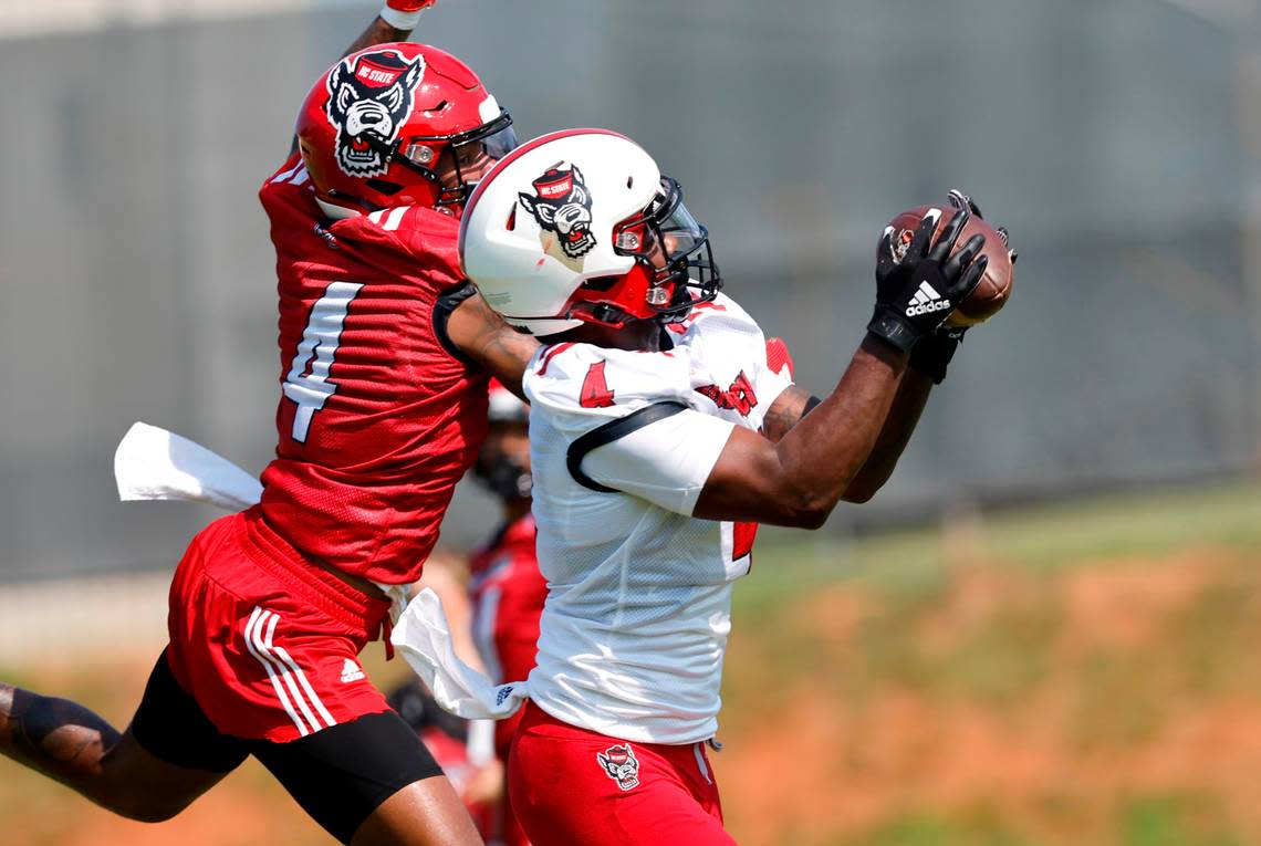 N.C. State wide receiver Porter Rooks (4) pulls in a pass while defended by safety Cyrus Fagan (4) during the Wolfpack’s first practice of fall camp in Raleigh, N.C., Wednesday, August 3, 2022.