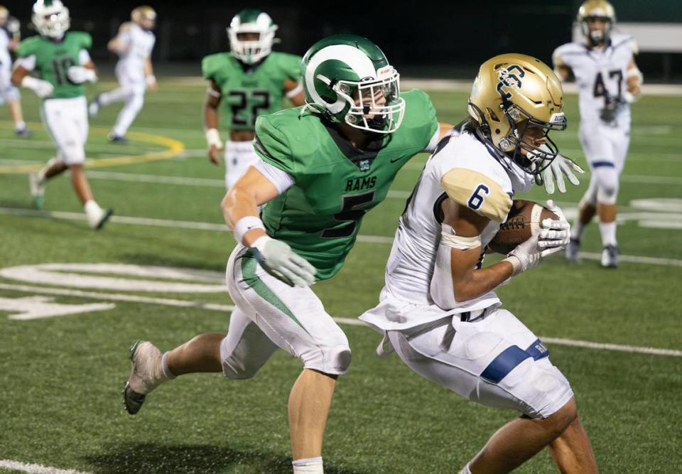 Central Catholic’s Brooklyn Cheek makes a catch along the sideline as St. Mary’s Brennan Carr defends during the game at St. Mary’s High School in Stockton, Calif., Friday, August 25, 2023.