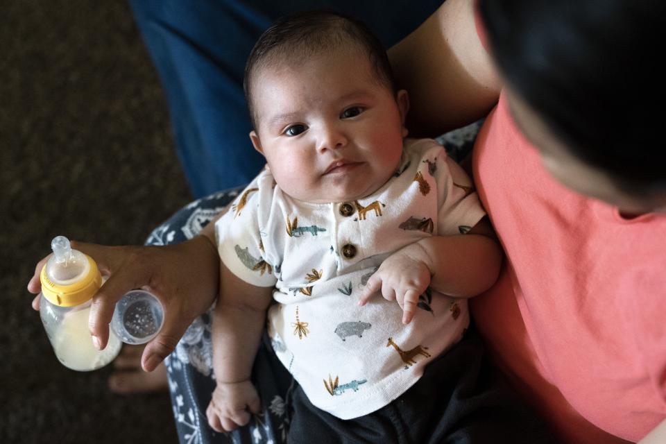 Yury Navas, 29, of Laurel, Md., holds her two-month-old baby, Ismael Galvaz, after feeding him with the only formula he can take without digestive issues, Enfamil Infant, from her dwindling supply of formula at their apartment in Laurel, Md., Monday, May 23, 2022. After this day's feedings she will be down to their last 12.5 ounce container of formula. Navas doesn't know why her breastmilk didn't come in for her third baby and has tried many brands of formula before finding the one kind that he could tolerate well, which she now says is practically impossible for her to find. To stretch her last can she will sometimes give the baby the water from cooking rice to sate his hunger. (AP Photo/Jacquelyn Martin)