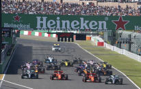 Mercedes driver Valtteri Bottas, right, of Finland passes Ferrari driver Sebastian Vettel of Germany at the start of the Japanese Formula One Grand Prix at Suzuka Circuit in Suzuka, central Japan, Sunday, Oct. 13, 2019. (AP Photo/Toru Hanai)