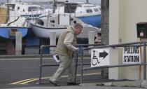 A voter arrives at a boathouse being used as a polling station, on polling day for the Northern Ireland Assembly elections, at Groomsport near Bangor in Northern Ireland, March 2, 2017. REUTERS/Toby Melville