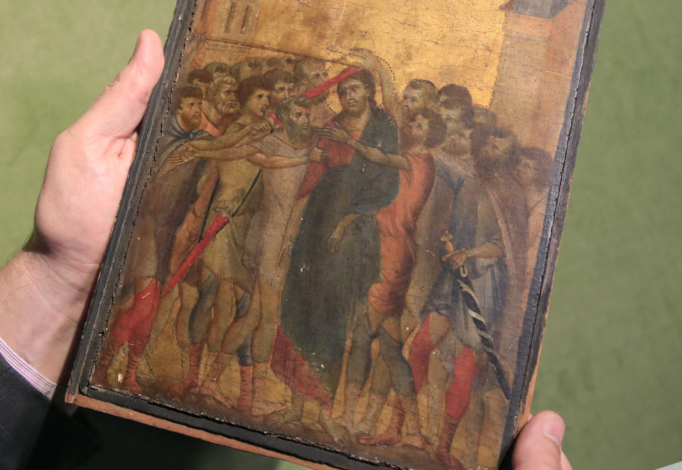 FILE - In this Tuesday, Sept. 24, 2019 file photo, art expert Stephane Pinta points to a 13th-century painting by Italian master Cimabue in Paris, Tuesday, Sept. 24, 2019. A masterpiece attributed to the 13th-century Italian painter Cimabue that was discovered in an elderly French woman&#39;s kitchen is expected to sell for millions at auction. Stephane Pinta, a painting specialist with the Turquin gallery in Paris, said an auctioneer spotted the painting while inspecting the woman&#39;s house in Compiegne in northern France and suggested she bring it to experts for an evaluation. (AP Photo/Michel Euler, File )