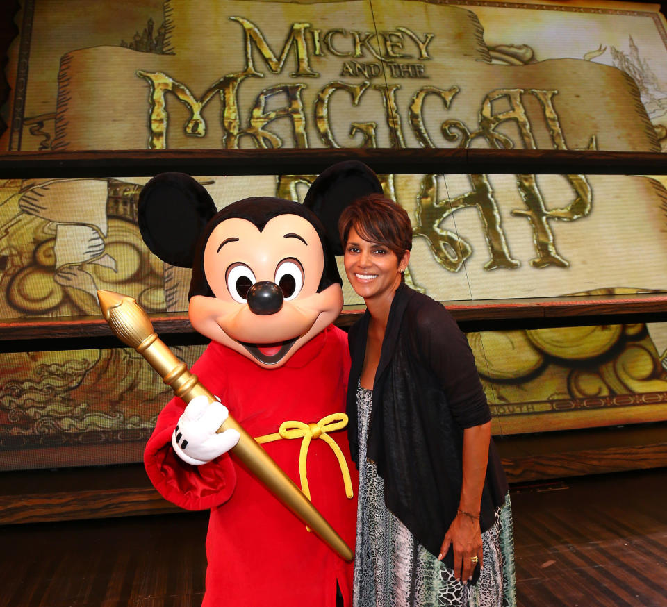 <p>ANAHEIM, CA - JULY 22: In this handout image provided by Disney Parks, actress Halle Berry meets Mickey Mouse on the stage of the new live musical show, 'Mickey and the Magical Map,' at Disneyland July 22, 2013 in Anaheim, California. (Photo by Paul Hiffmeyer/Disney Parks via Getty Images)</p>