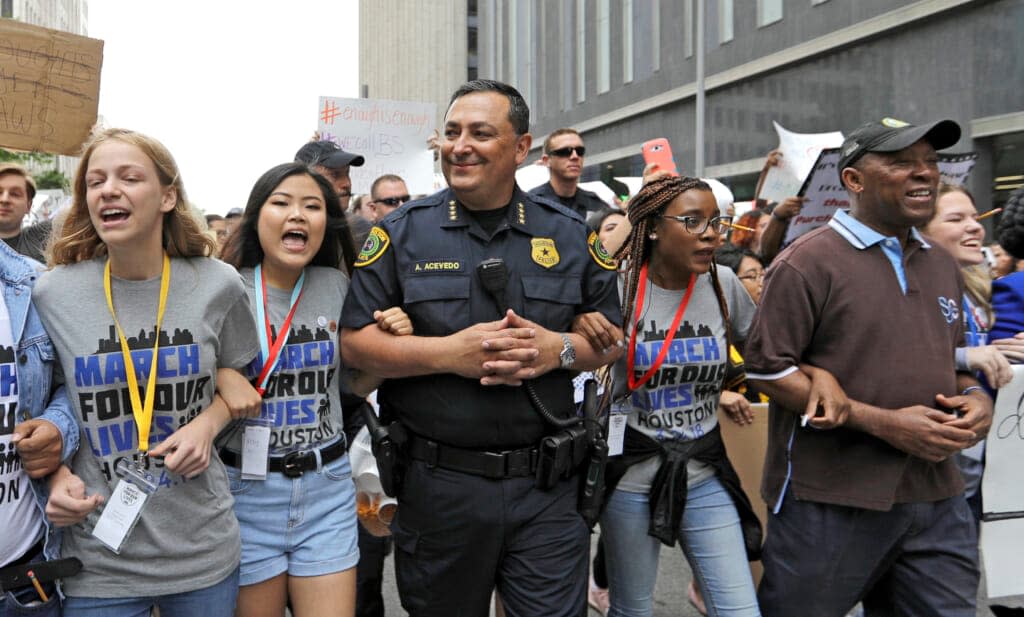 Houston Mayor Sylvester Turner (far right) – at a 2018 march in support of gun legislation with Houston Police Chief Art Acevedo (center), has said elected officials should not attend the NRA convention. (AP Photo/David J. Phillip, File)
