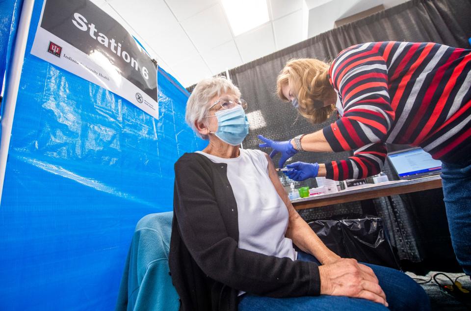 Iva Gloss gets her second dose of the Moderna COVID-19 vaccination Feb. 24 from Anne Fuson, a registered nurse with IU Health Bloomington, in the COVID-19 vaccination clinic in the Monroe Convention Center. (Rich Janzaruk / Herald-Times)