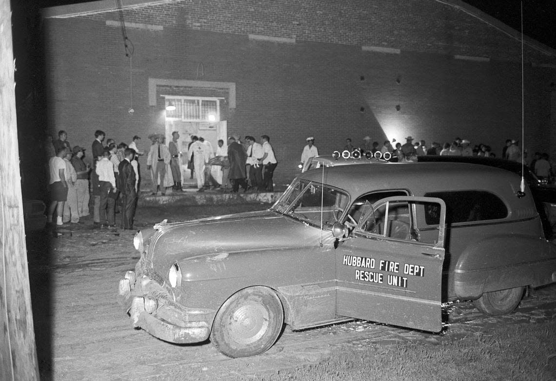 Volunteer workers set up a temporary morgue in a school gymnasium in Dawson, Texas, for victims of Braniff International airline crash in 1968. The red brick structure, built in the 1920s as a community center, is on Dawson’s busiest intersection. Bodies of the victims are seen being carted into the gym.