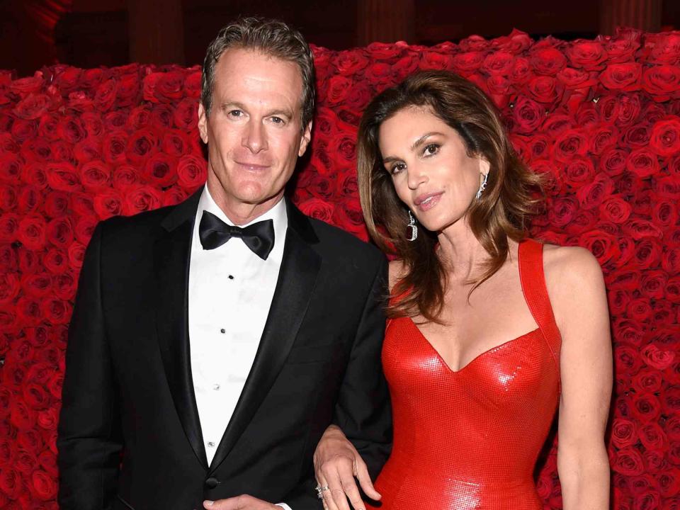 <p>Kevin Mazur/MG18/Getty</p> Rande Gerber and Cindy Crawford attend the 2018 Met Gala 