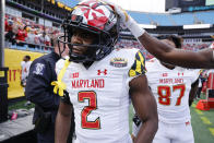 Teammates congratulate Maryland defensive back Jakorian Bennett after he intercepted a pass against North Carolina State during the second half of the Duke's Mayo Bowl NCAA college football game in Charlotte, N.C., Friday, Dec. 30, 2022. (AP Photo/Nell Redmond)