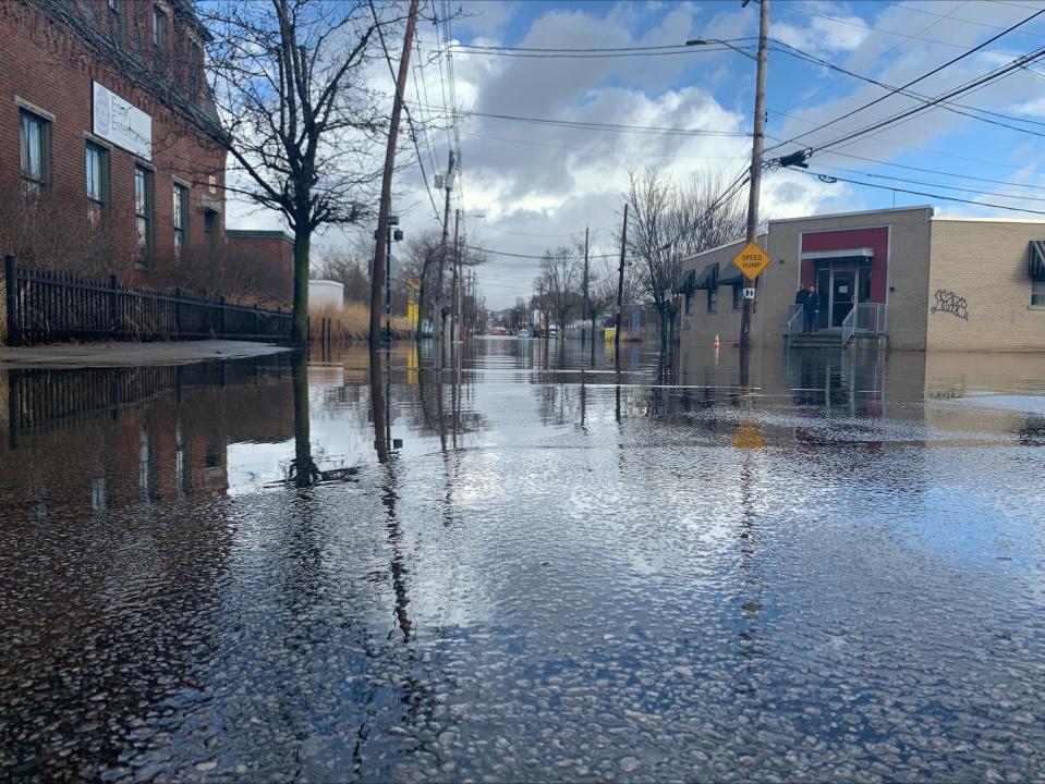 Valley Street in Providence is closed in front of the Rising Sun Mill, the road under feet of water, from the Woonasquatucket River.