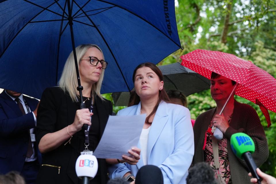 Detective Constable Natalie Horner, left, reads a statement to the media beside Sharlona Warner (PA)