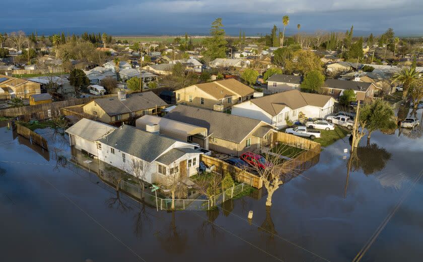 Following days of rain, floodwaters cover streets in the Planada community of Merced County, Calif., on Tuesday, Jan. 10, 2023. (AP Photo/Noah Berger)