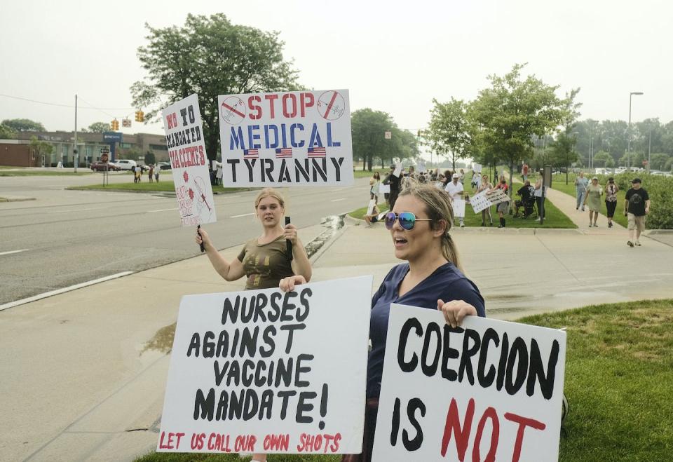 Nurses protesting the Biden administration’s vaccine mandate, which has since been suspended, in Michigan in July 2021. <a href="https://www.gettyimages.com/detail/news-photo/protesters-holding-placards-expressing-their-opinion-while-news-photo/1234168497?phrase=nurses" rel="nofollow noopener" target="_blank" data-ylk="slk:SOPA Images/LightRocket via Getty Images;elm:context_link;itc:0;sec:content-canvas" class="link ">SOPA Images/LightRocket via Getty Images</a>