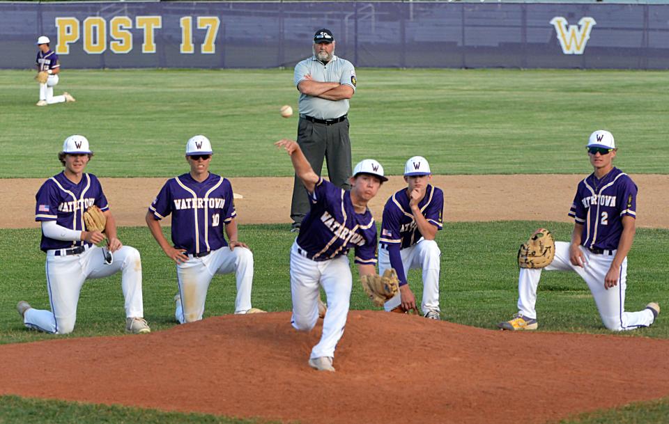 Watertown Post 17's Weston Everson warms up on the mound as teammates (from left), Marcus Rabine, Jack Heesch, Andrew Czech and Braedon Zaug look on during a game this season. In the background is umpire Doug Ruesink. Post 17 kicks off a key final stretch of their season by competing in the Gopher Classic this weekend in the Twin Cities.