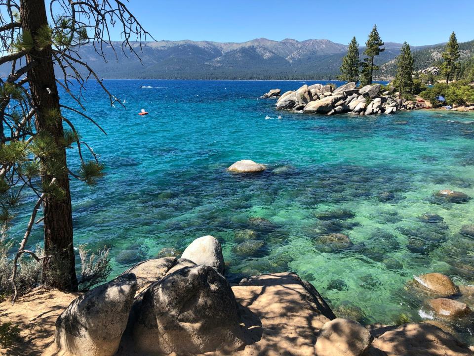 A view of turquoise water, rocky shores, and distant mountains at Lake Tahoe Nevada State Park