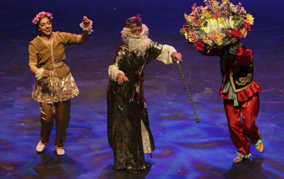 In this Sunday, March 10, 2019, dancers of Vancouver Pars National Ballet (VPNB), led by Azita Sahebjam, perform as Amu Nowruz, middle, who brings the message of the spring and the new year beginning, and Haji Firooz, right, during the Tirgan Nowruz Festival in Toronto, Canada. The event aims to preserve and celebrate Iranian and Persian culture, said festival CEO Mehrdad Ariannejad. Among those who attended were second-and third-generation immigrants, many of whom have never been to Iran or have not been there since leaving the country following the 1979 Islamic Revolution. (AP Photo/Kamran Jebreili)
