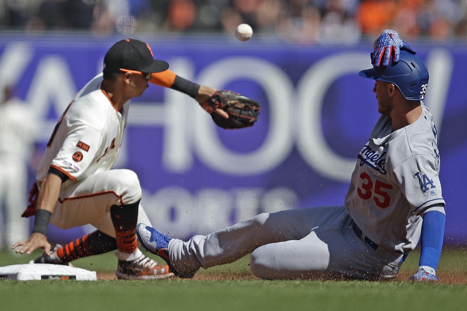 Los Angeles Dodgers' Cody Bellinger, right, slides into second base with a double as San Francisco Giants' Mauricio Dubon fields the ball in the fourth inning of a baseball game Saturday, Sept 28, 2019, in San Francisco. (AP Photo/Ben Margot)