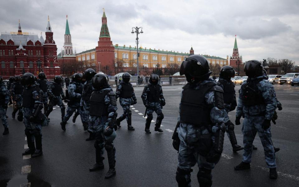 Russian riot police officers block a street near the Kremlin in Moscow - DIMITAR DILKOFF /AFP