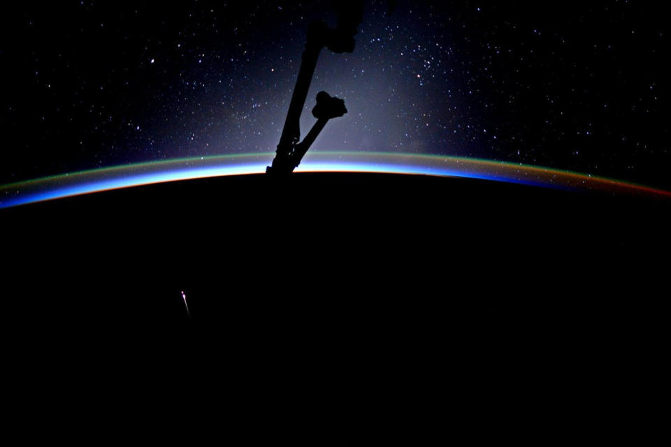 A Dragon cargo vehicle streaks through Earth's atmosphere after leaving the space station on July 3. NASA astronaut Jack Fisher tweeted this photo with the caption: "Beautiful expanse of stars-but the 'long' orange one is SpaceX-11 reentering! Congrats team for a successful splashdown & great mission!" <cite>Jack Fischer/NASA</cite>