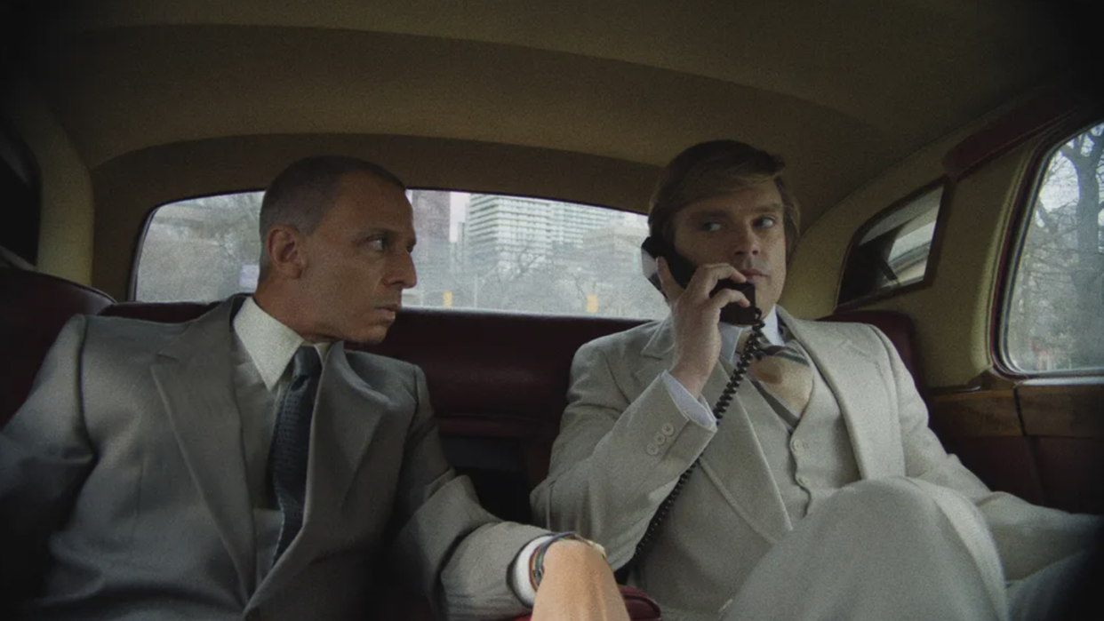 a man talking on a cell phone in a car