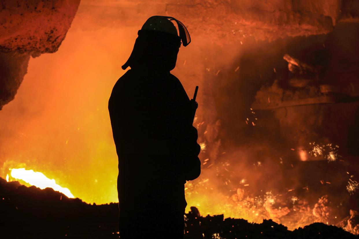 A steelworker watches as molten steel pours from one of the Blast Furnaces during 'tapping' at the British Steel - Scunthorpe plant in north Lincolnshire, north east England on September 29, 2016. Thursday September 29, marks 100 days since the British Steel conglomerate bought the ailing plant from Indian company Tata Steel. In a recent interview, Gareth Stace, director of UK Steel, Britain's steel trade organisation said, "I welcome that they have brought the British Steel brand back to life. I think fundamentally it's a good and viable business and should have a strong viable future." / AFP / Lindsey Parnaby        (Photo credit should read LINDSEY PARNABY/AFP via Getty Images)