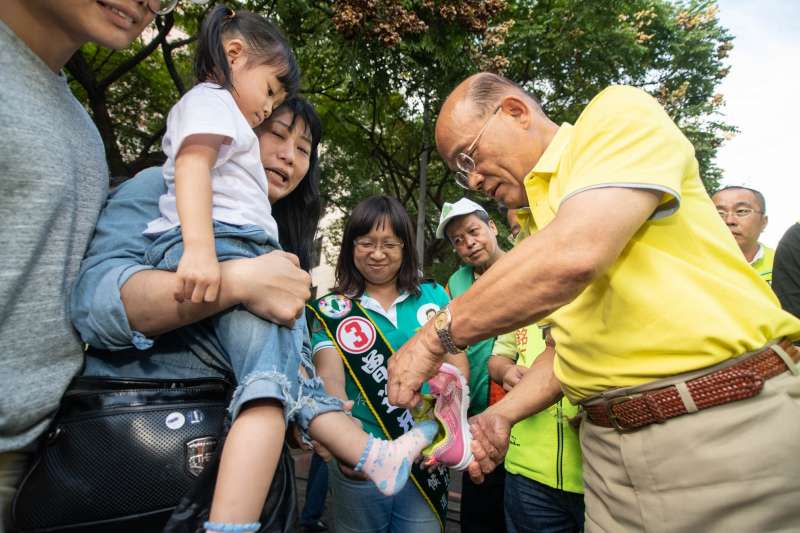 20181110-民進黨新北市長候選人蘇貞昌近來舉辦「玩趣總統員」遊樂園，今（10）加開樹林北大特區及土城場次，活動途中有小妹妹鞋子掉了，蘇貞昌更立刻化身「暖男」幫小妹妹撿起來穿上。（蘇貞昌辦公室提供）