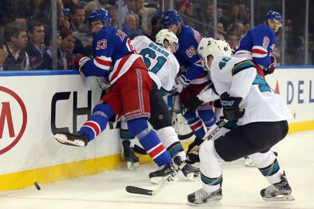 Oct 23, 2017; New York, NY, USA; New York Rangers center Mika Zibanejad (93) kicks the puck out of a scrum during the second period against the San Jose Sharks at Madison Square Garden. Mandatory Credit: Brad Penner-USA TODAY Sports