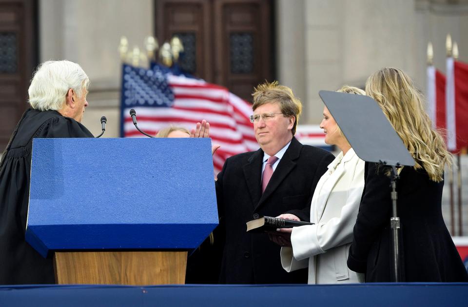 Chief Justice Mike Randolph issues the oath of office to Gov. Tate Reeves as his wife Elee Reeves holds the Bible during the inauguration ceremony at the state Capitol in Jackson, Miss., Tuesday, Jan. 9, 2023. Reeves, the 65th governor of the state, begins his second term.