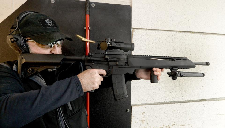 Gary Hutchens of Decatur fires an AR-15 rifle at the Bullet Trap rifle and pistol range in Macon on Wednesday.