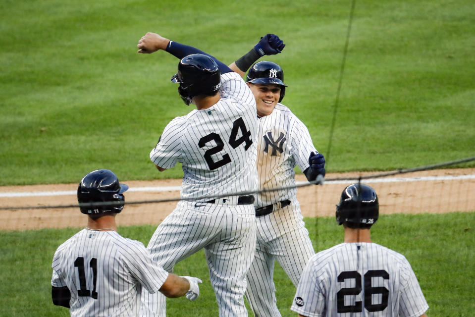 New York Yankees' Gio Urshela, top right, celebrates with teammate Gary Sanchez (24) after hitting a grand slam off Boston Red Sox starting pitcher Zack Godley in the second inning of a baseball game Saturday, Aug. 1, 2020, in New York. (AP Photo/John Minchillo)