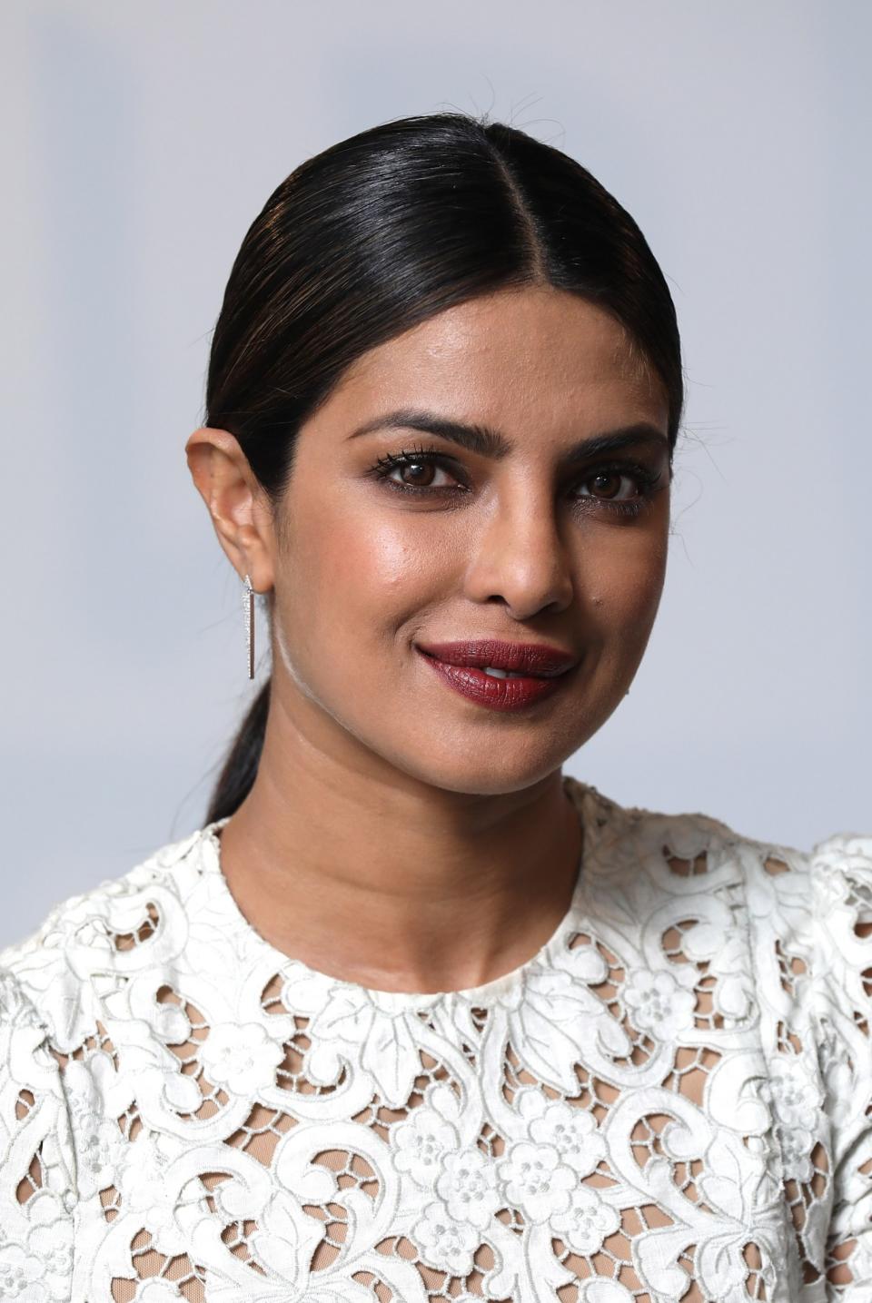 <p>The <em>Baywatch</em> star kept her look simple yet chic for a Build London event with a sleek, center-parted ponytail, subtle smoky eye makeup, and brick-red lipstick. (Photo: Getty Images) </p>