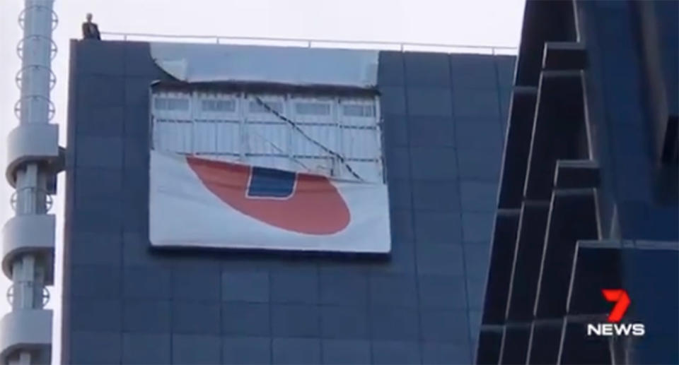 Wild winds ripped and dislodged the 4x6m canvas placard on the skyscraper on Monday morning. Source: 7 News