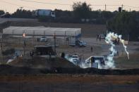 Israeli soldiers and Palestinian protesters clash near the border between Israel and the Gaza Strip as seen from the Israeli side