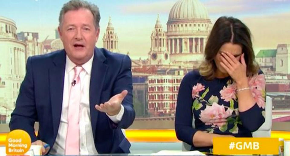 Pictured is Piers Morgan and Susanna Reid, who has her hand to her face, in the Good Morning Britain studio