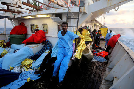 FILE PHOTO: Alaedba, 20, from Senegal, sits aboard the former fishing trawler Golfo Azzurro of the Spanish NGO Proactiva Open Arms, after being rescued with other migrants near the coasts of Libya, in the central Mediterranean Sea, January 28, 2017. REUTERS/Giorgos Moutafis/File Photo