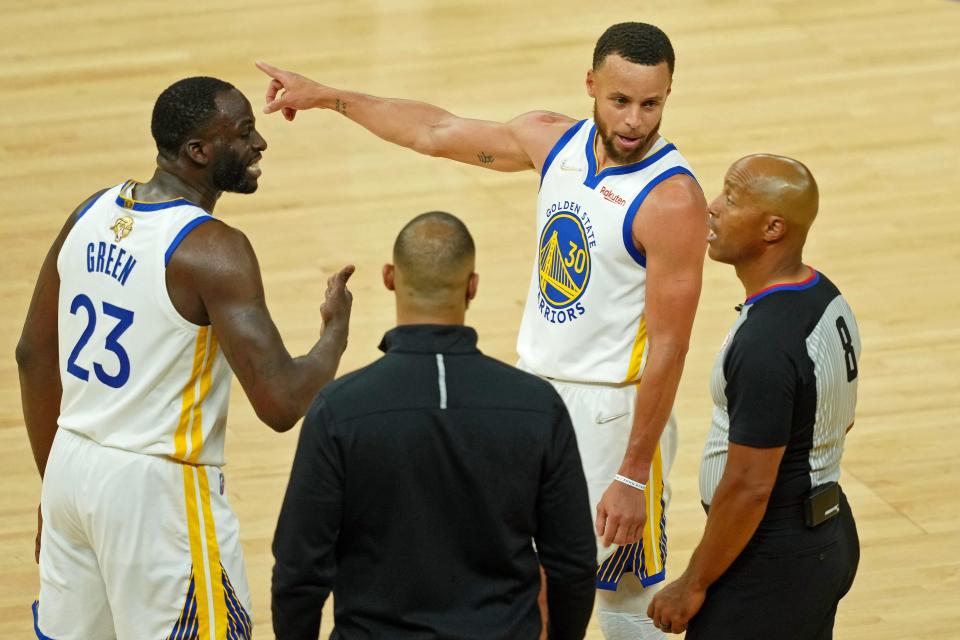 Draymond Green and Stephen Curry plead their case with referee Marc Davis during the second half of Game 1.