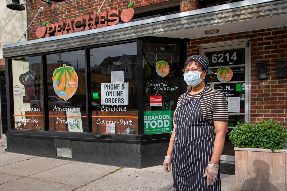 Peaches Watson stands outside Peaches Kitchen Restaurant & Catering Service in Washington, D.C. She said she is struggling to keep her business open amid the coronavirus shutdowns.