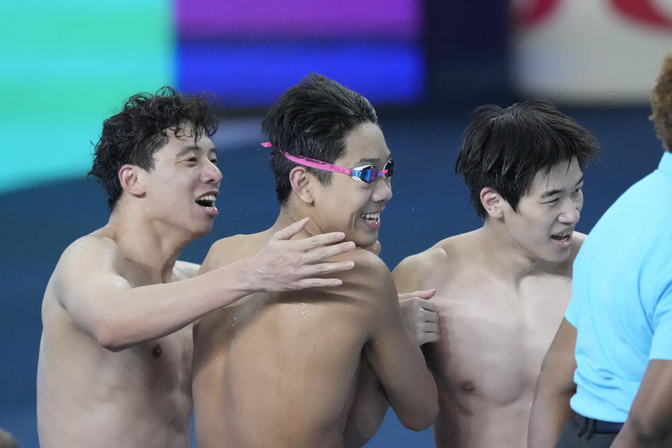 Team China celebrate after competing the men's 4x100-meter freestyle final at the World Aquatics Championships in Doha, Qatar, Sunday, Feb. 11, 2024. (AP Photo/Lee Jin-man)