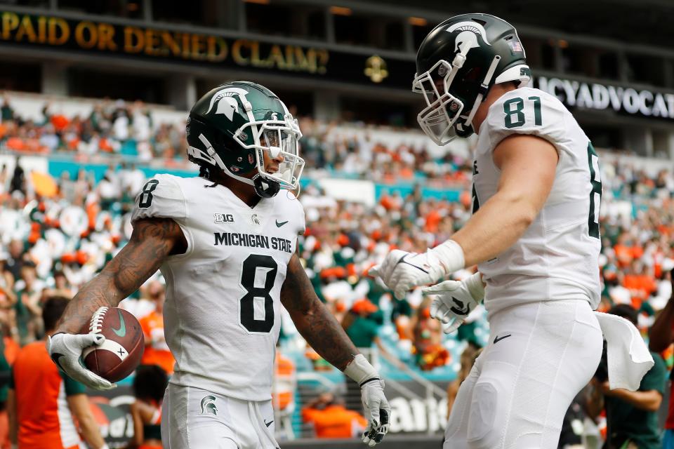 Michigan State wide receiver Jalen Nailor (8) celebrates with tight end Parks Gissinger (81) after a touchdown during the third quarter of an NCAA college football game against Miami, Saturday, Sept. 18, 2021, in Miami Gardens, Fla. (AP Photo/Michael Reaves)