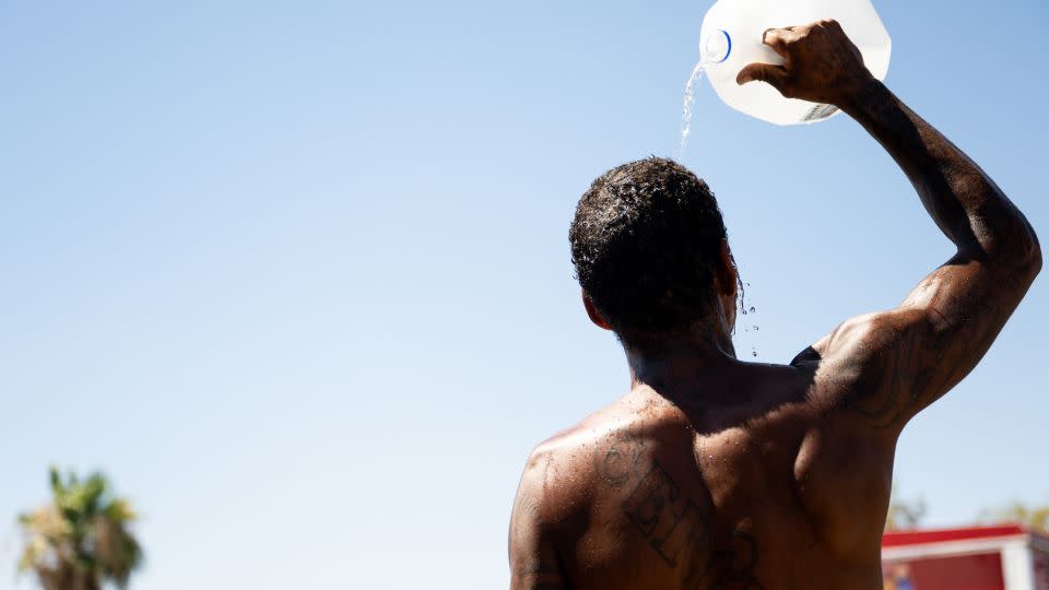 A person cools off amid searing heat on July 16, 2023, in Phoenix. A heat dome over Texas that has expanded to California, Nevada and Arizona is subjecting millions of Americans to excessive heat. warnings, according to the National Weather Service.  - Brandon Bell/Getty Images