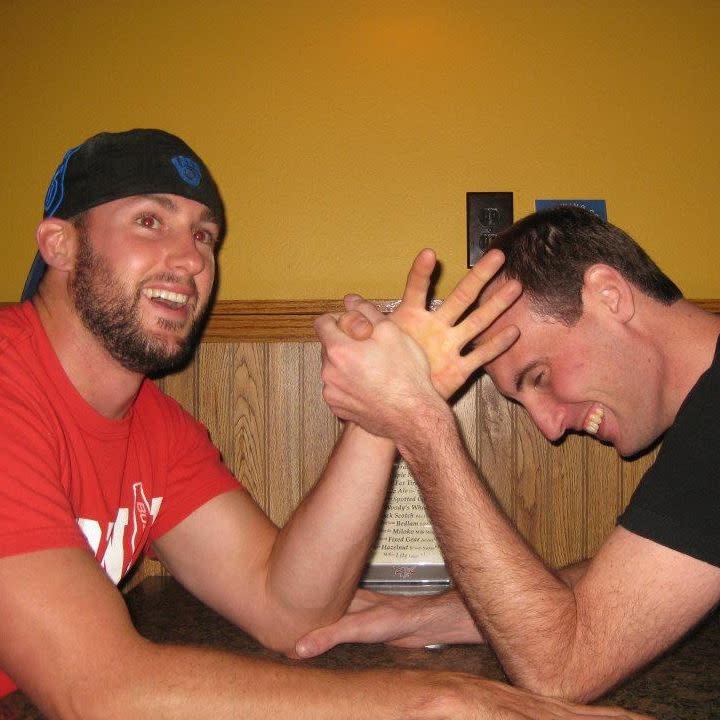 In this 2012 photo provided by Joseph Kindred, Justin Lentz, left, 32, and Jarrard Law, 34, both of Portage, Wis., arm wrestle. Relatives say the two men were skiing Saturday, Feb. 15, 2014, near Leadville, Colo., when they were killed in an avalanche that also left three others with moderate injuries. (AP Photo/Joseph Kindred)