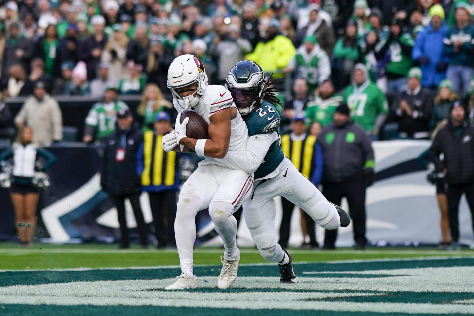 Arizona Cardinals wide receiver Michael Wilson, left, catches a touchdown pass in front of Philadelphia Eagles cornerback Kelee Ringo (22) during the second half of an NFL football game, Sunday, Dec. 31, 2023, in Philadelphia. (AP Photo/Matt Slocum)