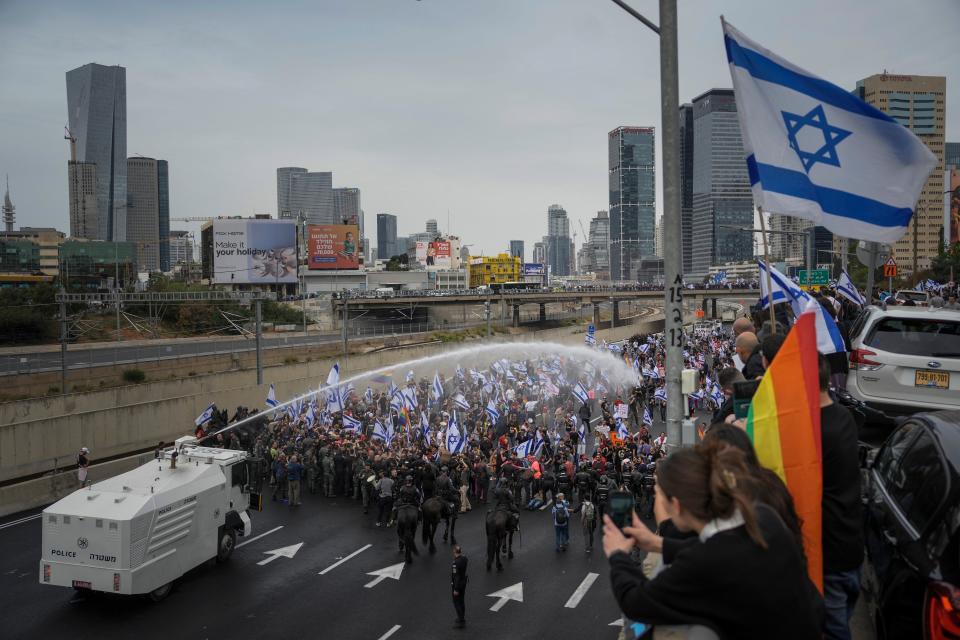 sraeli police use a water cannon to disperse Israelis blocking the freeway during a protest (Copyright 2023 The Associated Press. All rights reserved.)