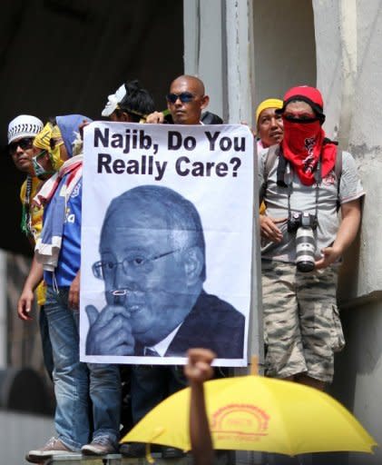 A protester is seen holding a picture of Malaysia's prime Minister Najib Razak during a mass rally organized by Bersih 3.0, calling for electoral reform, in Kuala Lumpur, in April 2012. Thousands of protesters gathered in the Malaysian capital to demand electoral reforms, defying a lockdown of central Kuala Lumpur