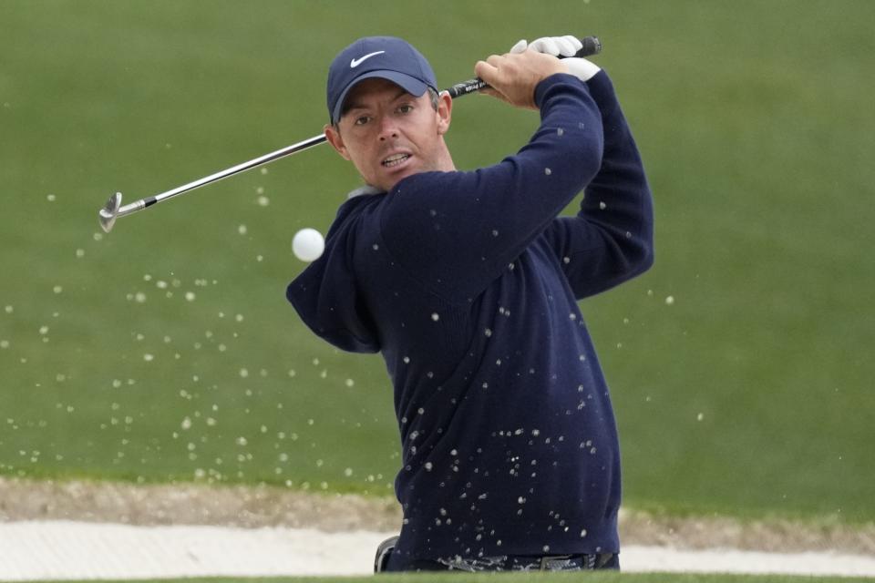 FILE - Rory McIlroy, of Northern Ireland, hits out of a bunker on the 16th hole during a practice for the Masters golf tournament at Augusta National Golf Club, Monday, April 3, 2023, in Augusta, Ga. McIlroy is expected to compete in the PGA Championship next week at Oak Hill Country Club in Pittsford, N.Y.(AP Photo/Mark Baker, File)